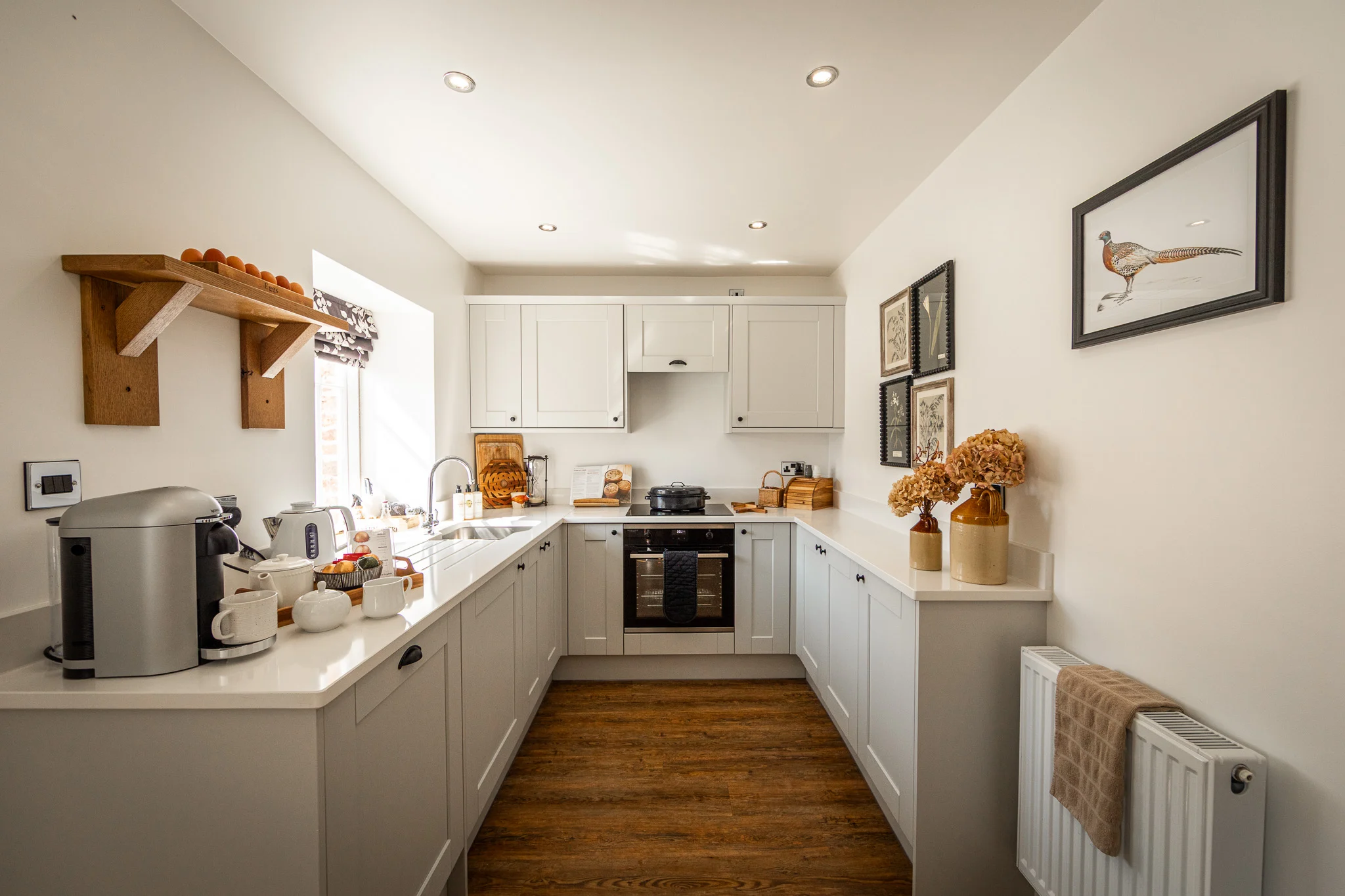 Kitchen at Pheasant Cottage, Peplow Hall Estate featuring modern appliances, shaker-style cabinetry and warm country house styling.